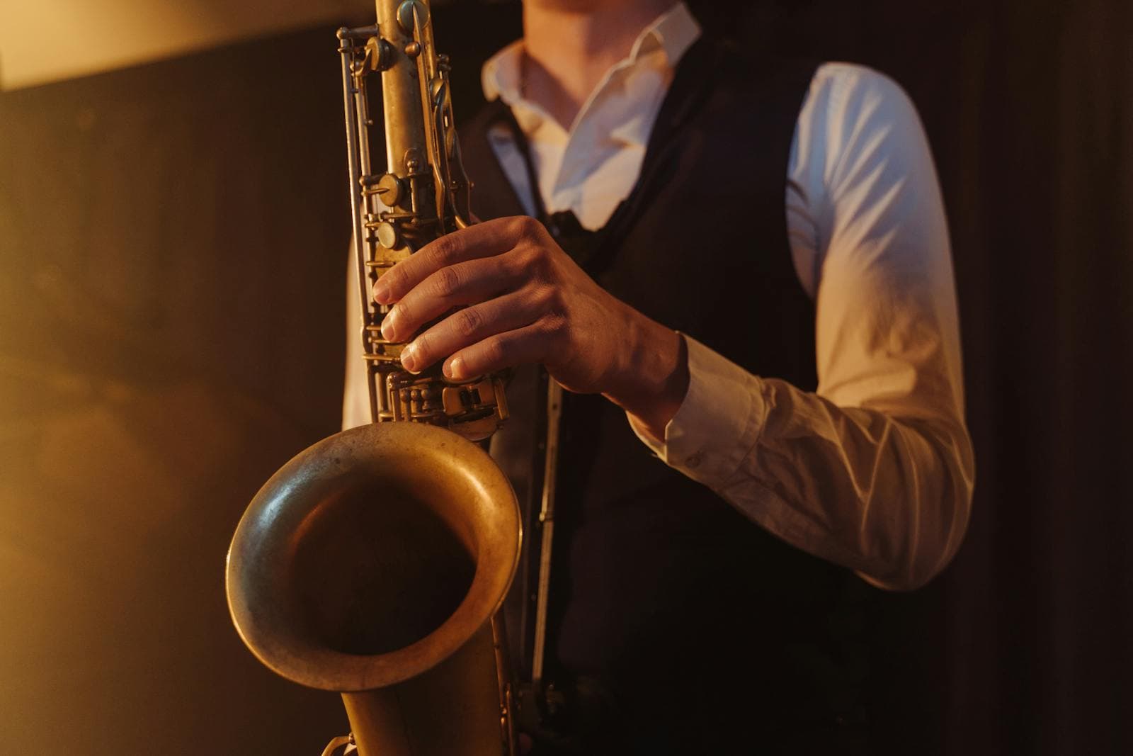 Live band sax player performing off stage at a destination wedding DJ set