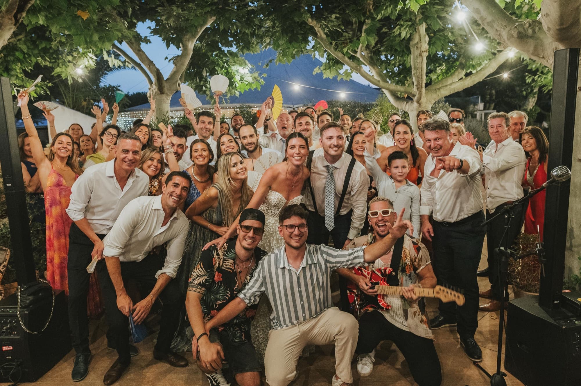 Outdoor destination wedding in Catalonia at golden hour, guests around long tables