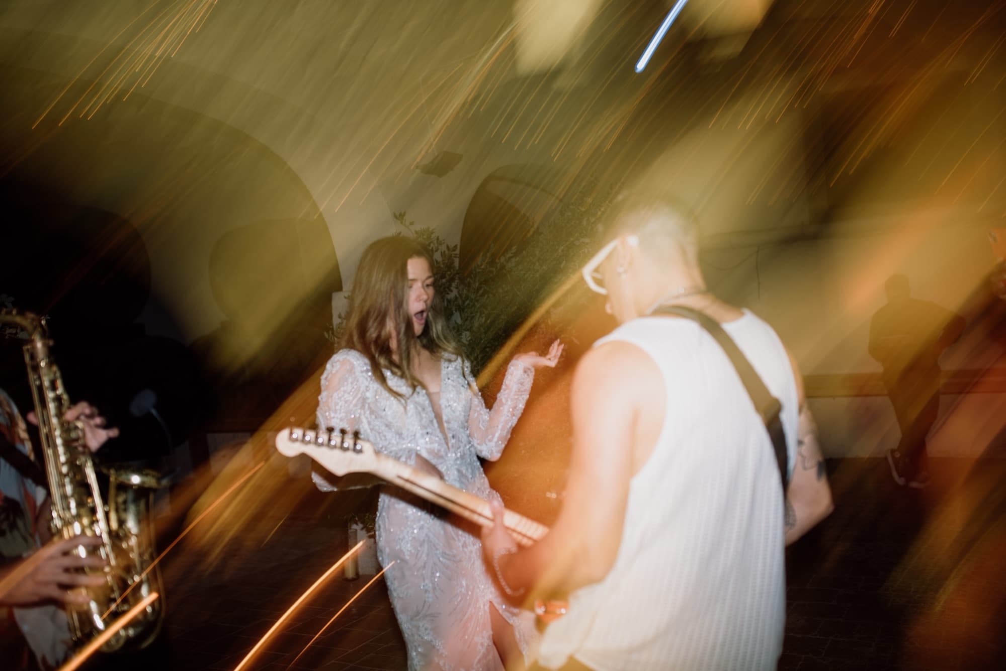 Guests seated at long tables during a destination wedding cocktail hour in Spain