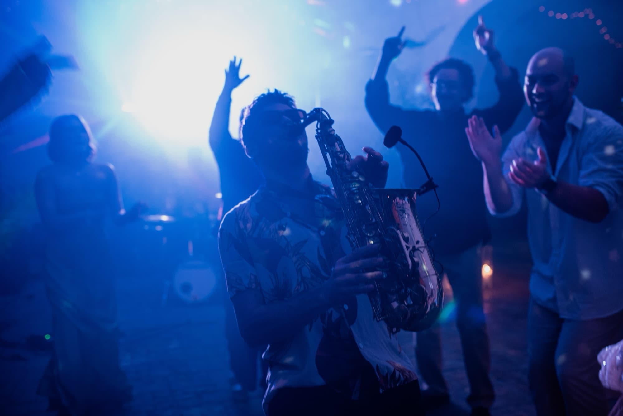 Savage Party live band playing sax in the middle of a destination wedding crowd in Spain